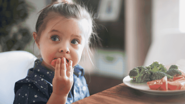 a-little-girl-eating-vegetables