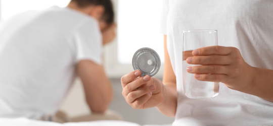 Woman taking emergency contraception pill