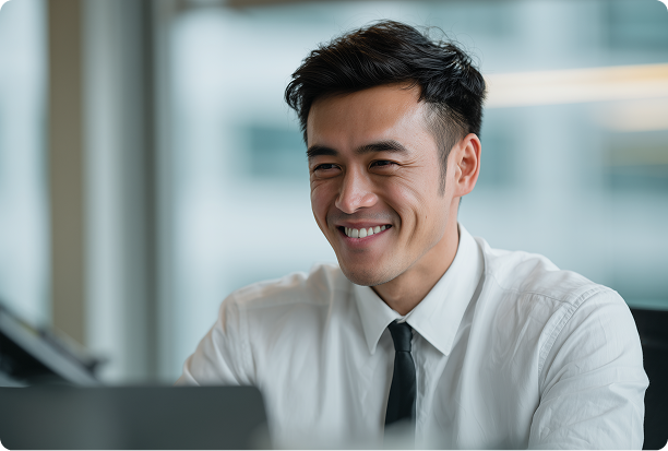 man wearing a dress shirt and black tie working in an office